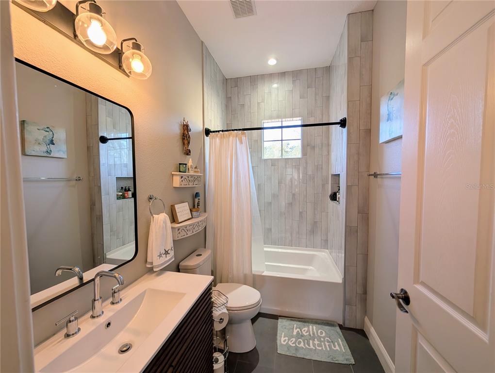 7429 Gathering Court Reunion, FL 34747 - Photo 28 of 40 a bathroom with a granite countertop sink toilet and shower
