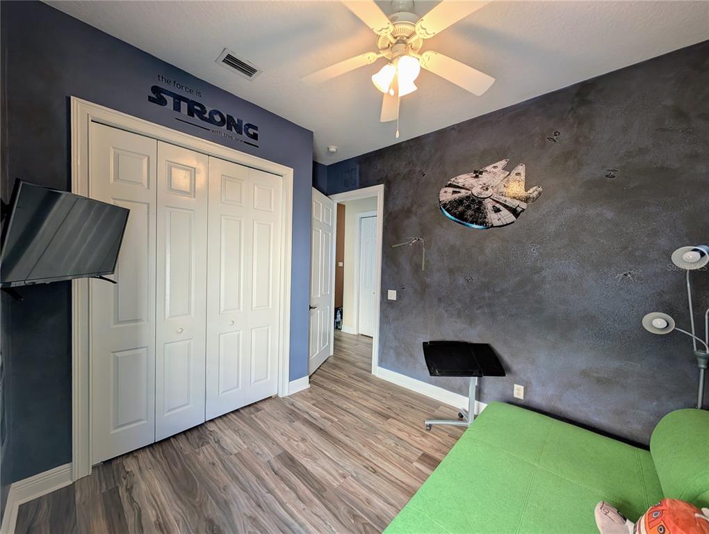 7429 Gathering Court Reunion, FL 34747 - Photo 30 of 40 a bedroom with a bed and a chandelier