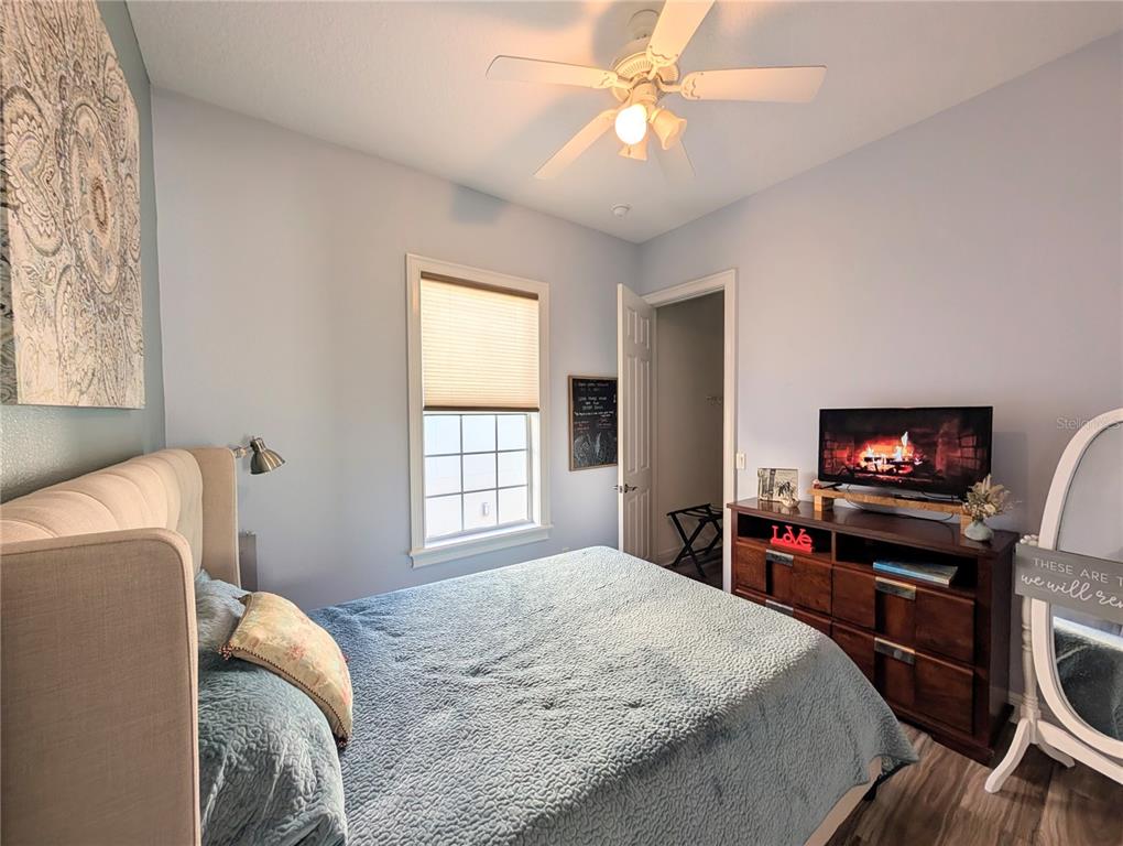 7429 Gathering Court Reunion, FL 34747 - Photo 31 of 40 a bedroom with a bed and a flat screen tv