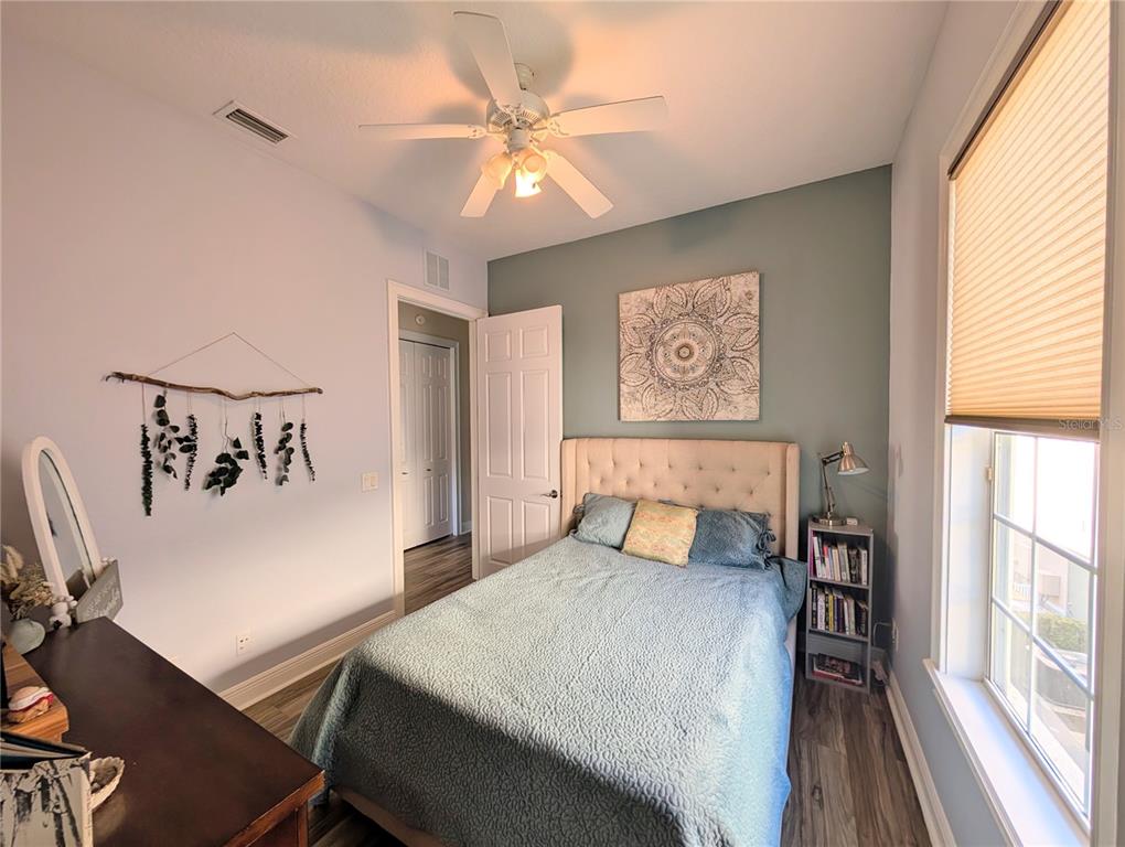 7429 Gathering Court Reunion, FL 34747 - Photo 32 of 40 a bedroom with a large bed and a chandelier