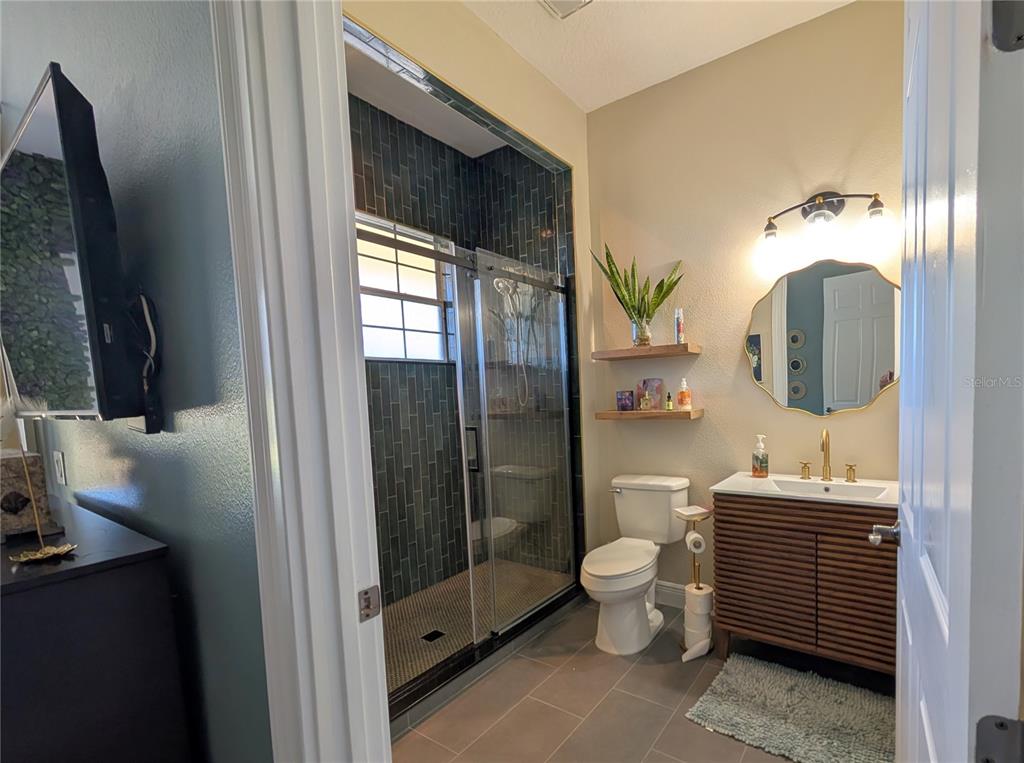 7429 Gathering Court Reunion, FL 34747 - Photo 34 of 40 a bathroom with a toilet sink and shower