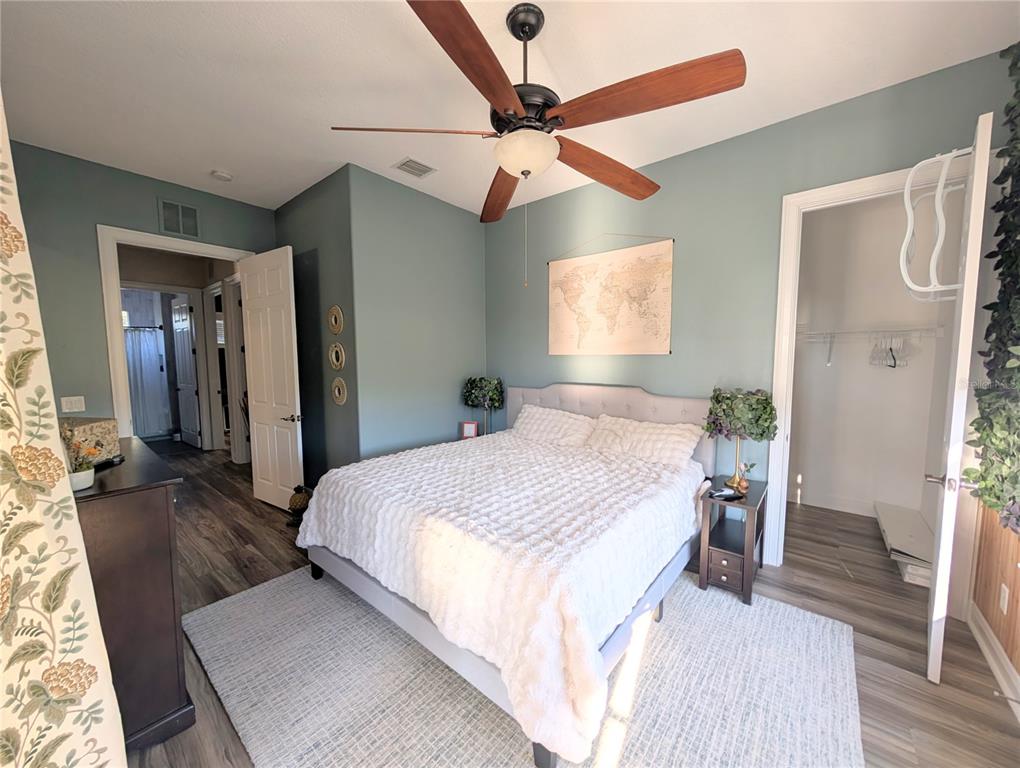7429 Gathering Court Reunion, FL 34747 - Photo 35 of 40 a spacious bedroom with a bed and wooden floor