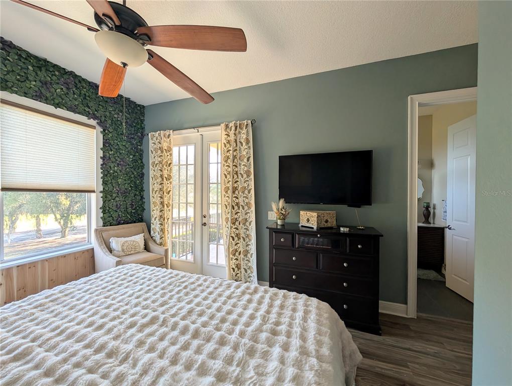 7429 Gathering Court Reunion, FL 34747 - Photo 36 of 40 a bedroom with a bed and a flat screen tv