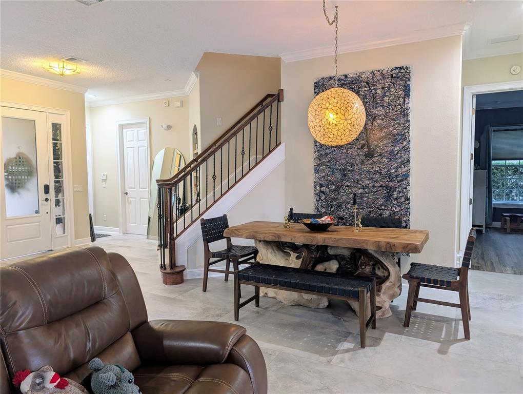 7429 Gathering Court Reunion, FL 34747 - Photo 10 of 40 a living room with furniture a rug and a chandelier