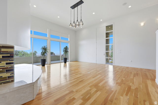 1389 Millbrook Way Bountiful, UT 84010 - Photo 19 of 74 Spacious room featuring wood-finish flooring, a contemporary multi-globe chandelier, and recessed lighting