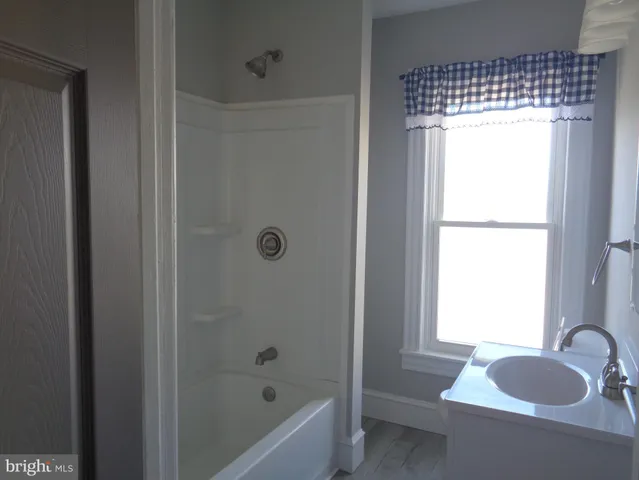 a kitchen with granite countertop a refrigerator stove and sink