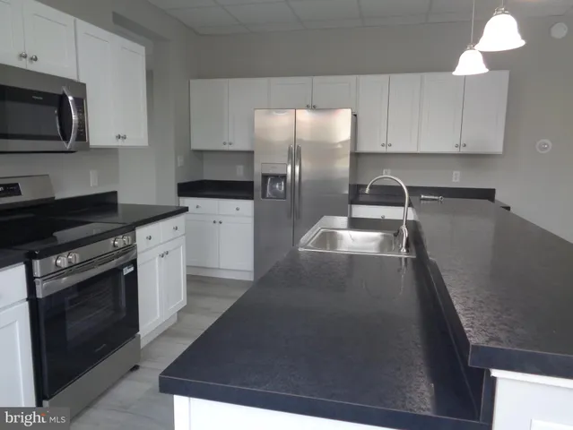 a kitchen with a sink and a window