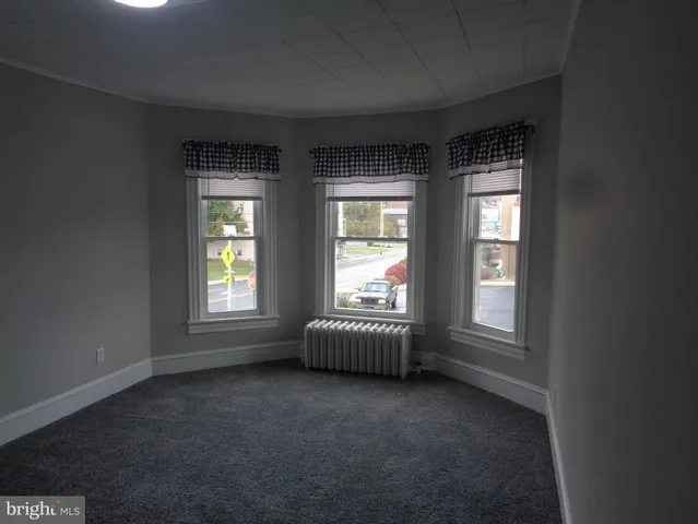 a view of an empty room with a closet