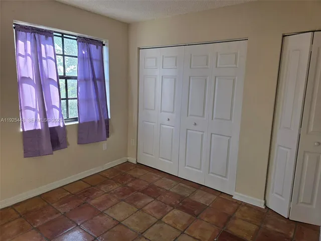 a white toilet sitting next to a shower