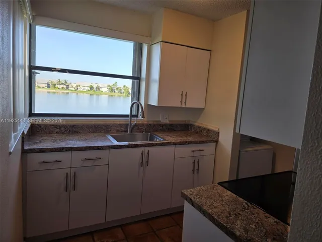 a view of a big room with a chandelier fan