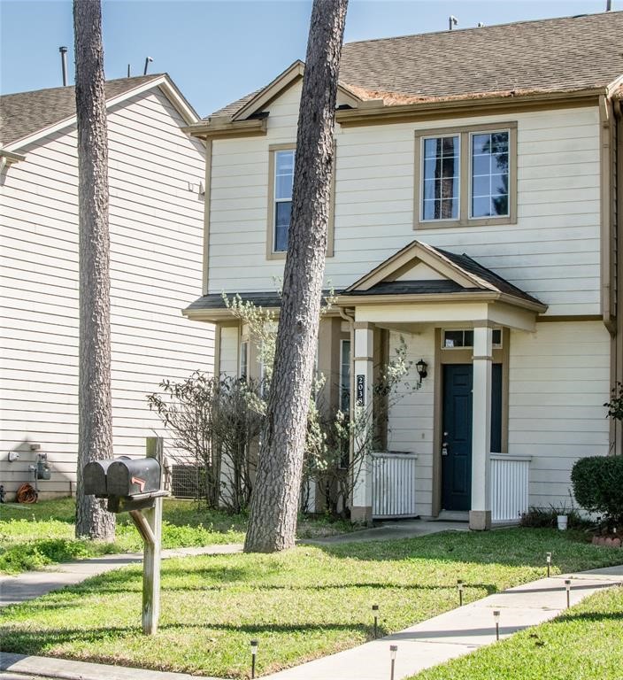 2038 Rustling Trees Way Spring, TX 77373 - Photo 2 of 20 a front view of a house with a yard