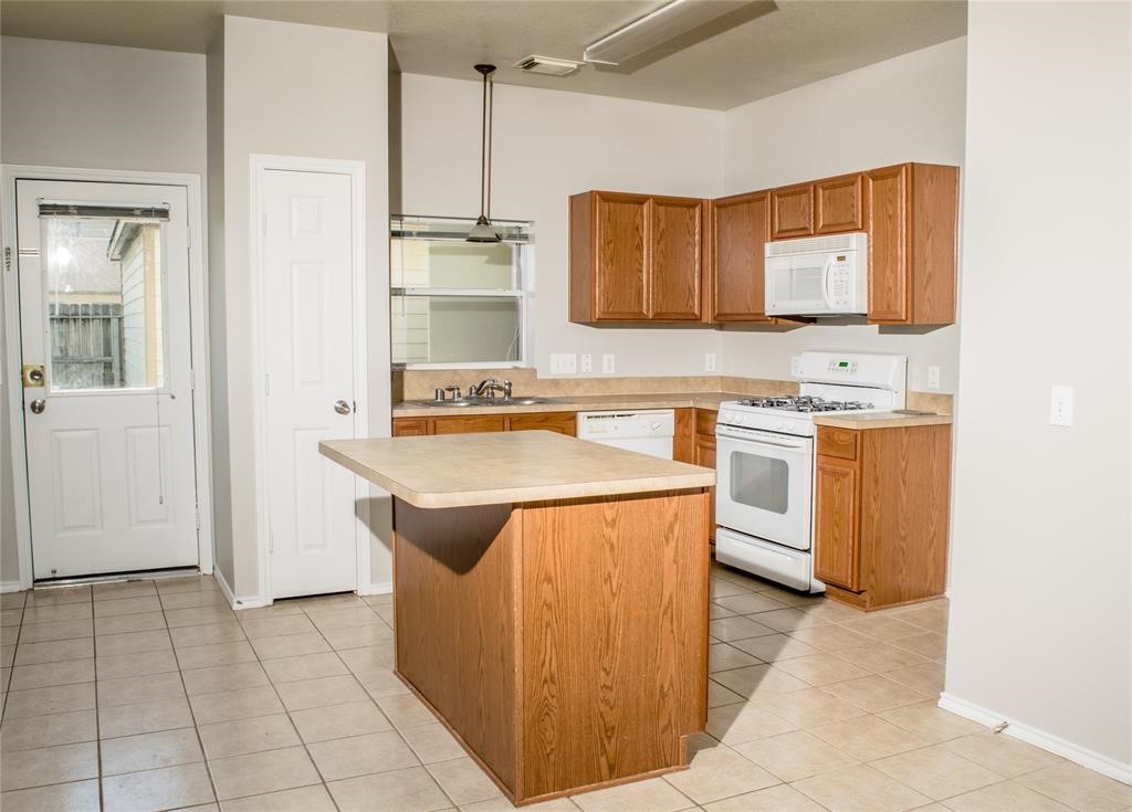 2038 Rustling Trees Way Spring, TX 77373 - Photo 8 of 20 a kitchen with stainless steel appliances granite countertop a sink stove and refrigerator