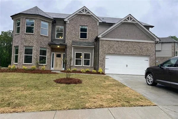 a front view of a house with a yard