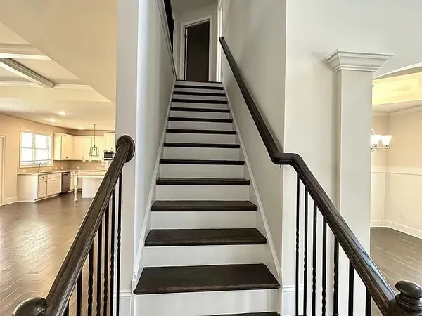 a view of entryway and hall with wooden floor