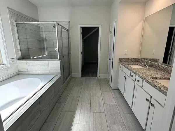 an empty room with windows and ceiling fan