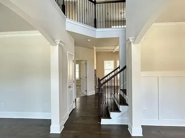 a view of staircase with wooden floor and a rug