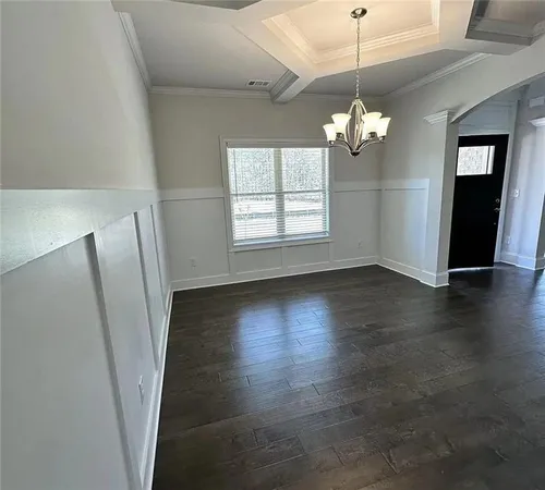 a view of a livingroom with wooden floor and a ceiling fan
