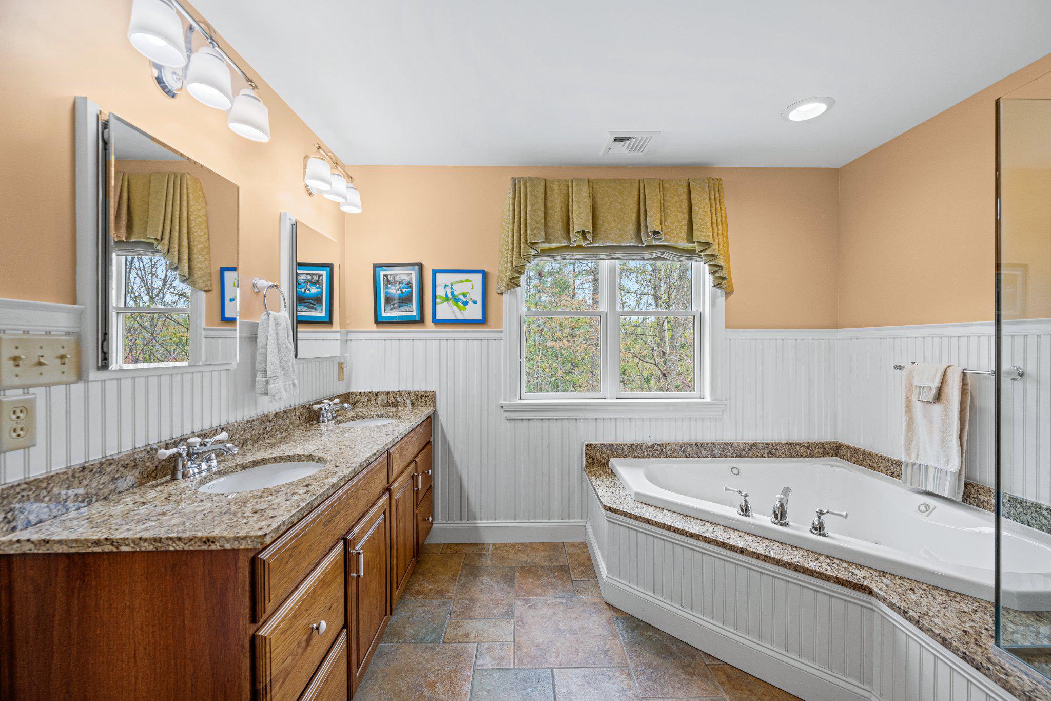 21042 Millers Mill Road Freeland, MD 21053 - Photo 109 of 122 a spacious bathroom with a granite countertop tub sink and mirror