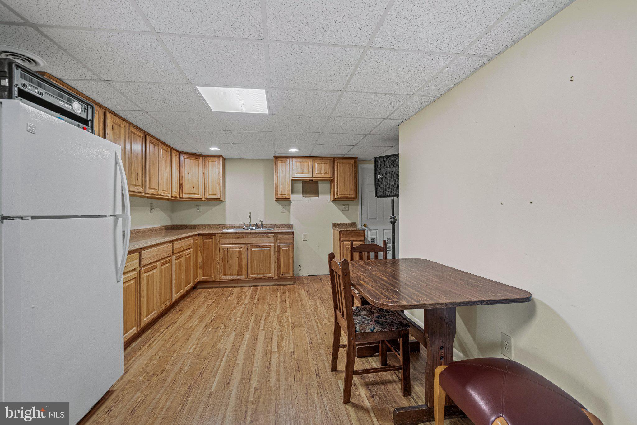 21042 Millers Mill Road Freeland, MD 21053 - Photo 113 of 122 a kitchen with cabinets wooden floor and stainless steel appliances