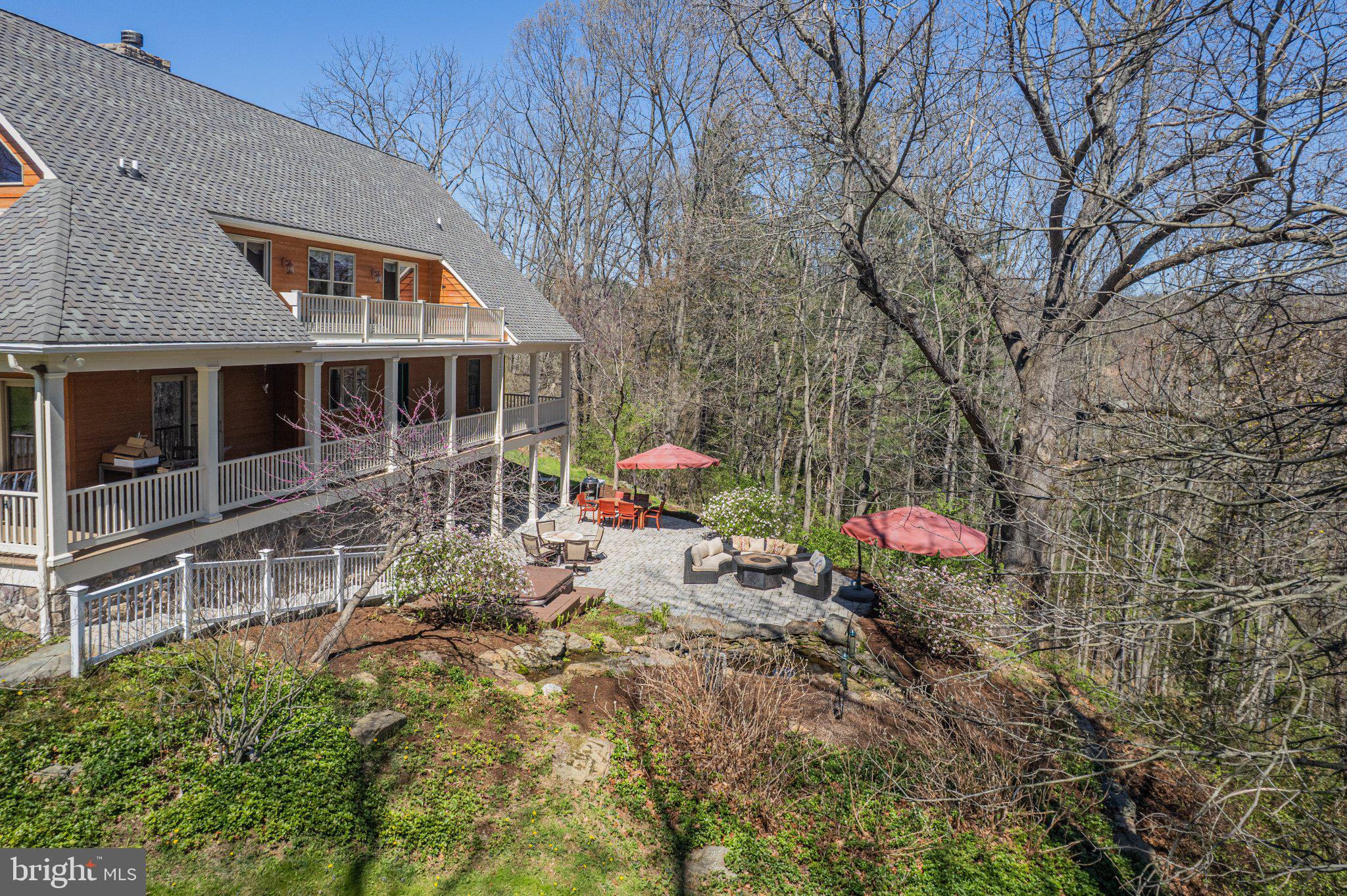 21042 Millers Mill Road Freeland, MD 21053 - Photo 14 of 122 a backyard of a house with table and chairs under an umbrella