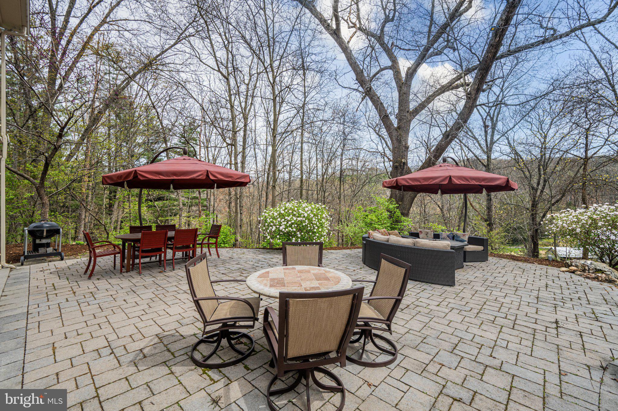 21042 Millers Mill Road Freeland, MD 21053 - Photo 65 of 122 a view of a patio with a table and chairs under an umbrella