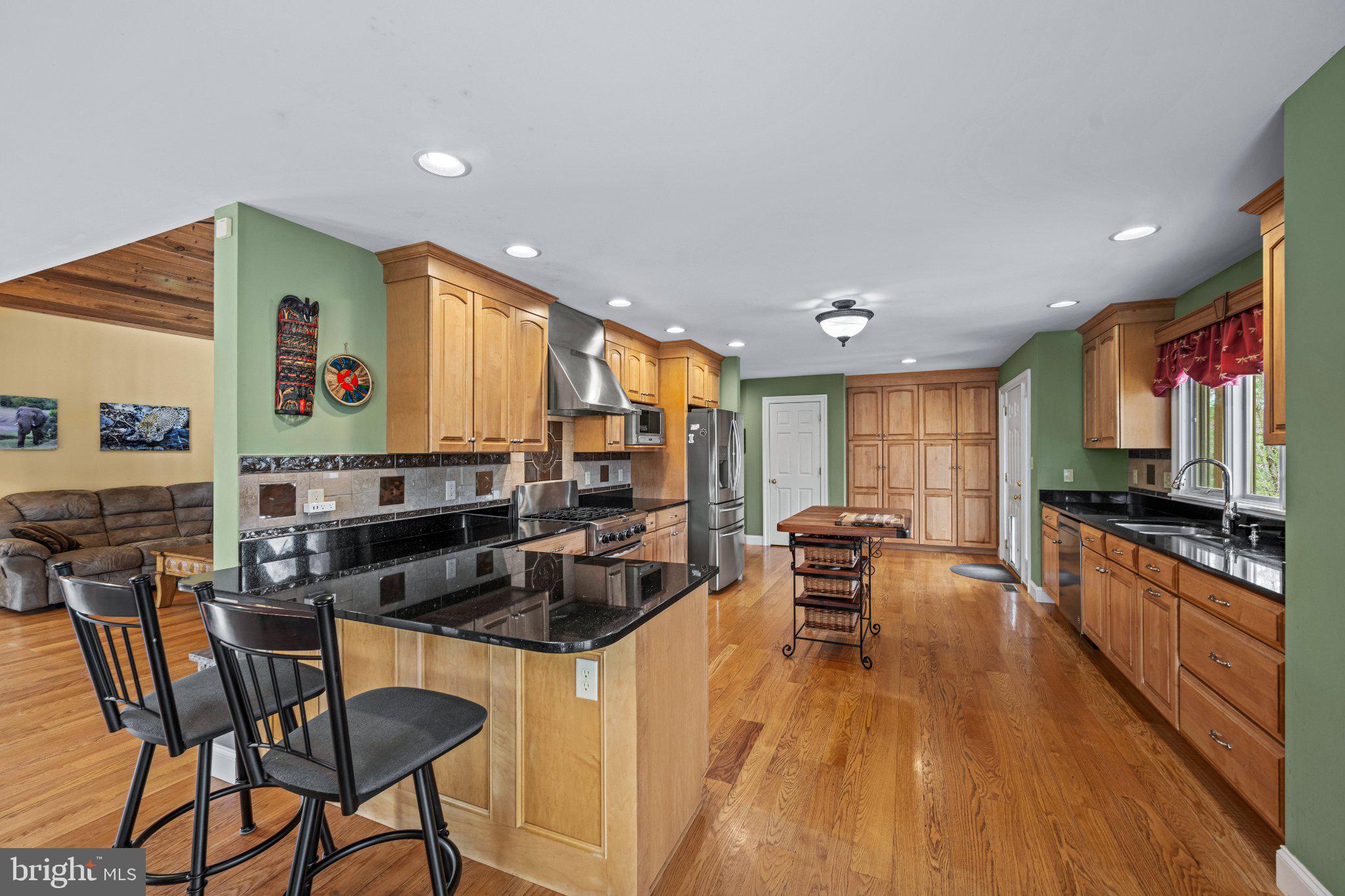 21042 Millers Mill Road Freeland, MD 21053 - Photo 82 of 122 a kitchen with a table chairs stove and cabinets