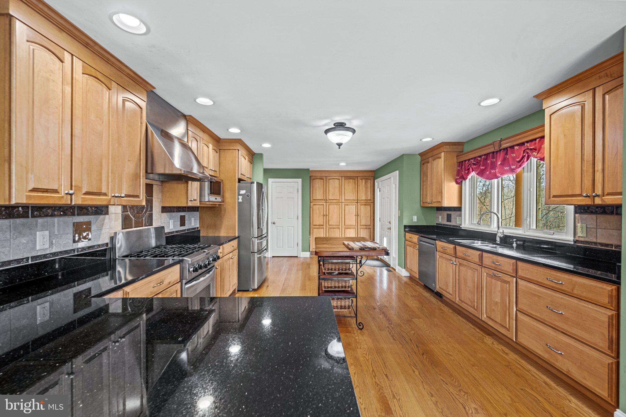 21042 Millers Mill Road Freeland, MD 21053 - Photo 86 of 122 a open kitchen with stainless steel appliances granite countertop a stove top oven a sink dishwasher and cabinets with wooden floor