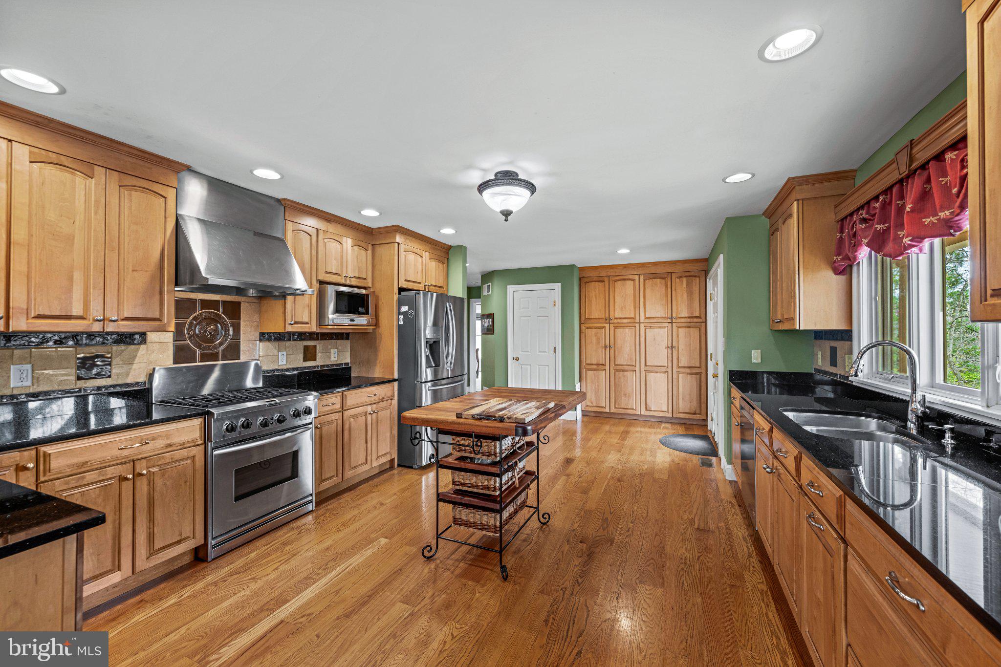 21042 Millers Mill Road Freeland, MD 21053 - Photo 87 of 122 a kitchen with stainless steel appliances a stove a sink dishwasher a refrigerator with wooden floor and cabinets