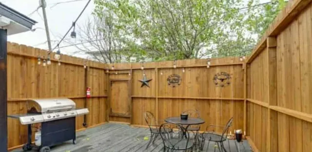 a view of a backyard with table and chairs