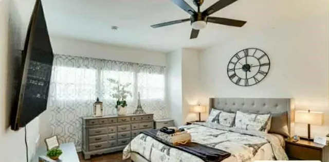 a bedroom with a bed and a chandelier