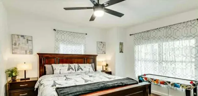 a bedroom with a bed and a window