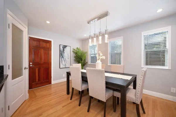 a view of a dining room with furniture window and wooden floor