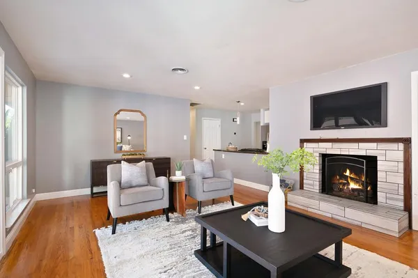 a living room with furniture and a fireplace