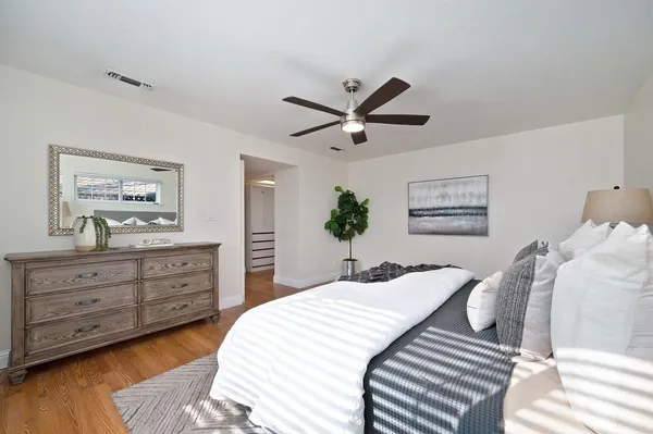 a bedroom with a bed and a dresser