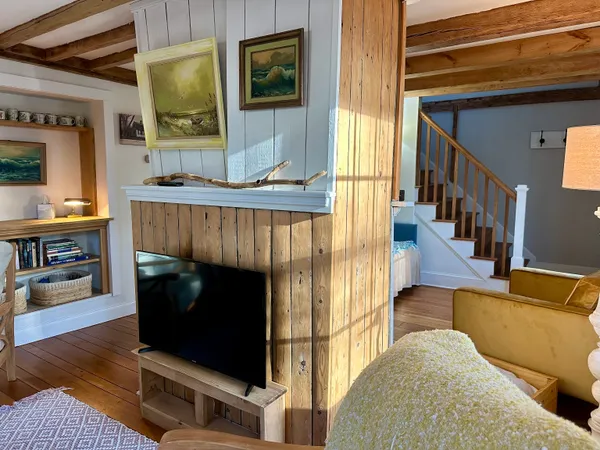 a living room with furniture a fireplace and a flat screen tv