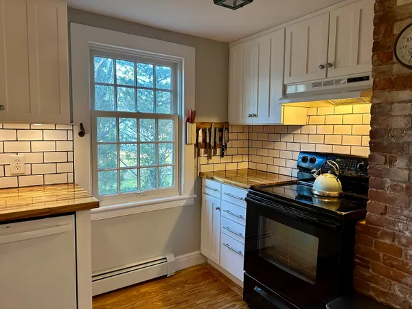 a kitchen with granite countertop a stove and a sink