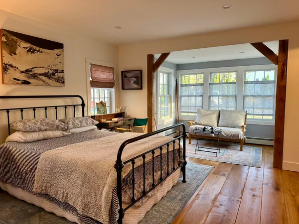 a bedroom with double bed and a large window