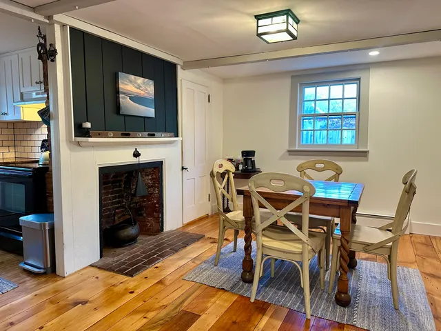 a view of a dining room with furniture and a flat screen tv
