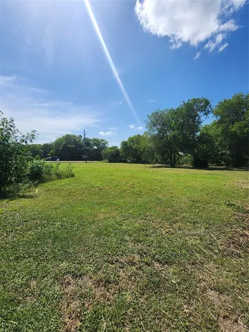 a view of a field with an ocean