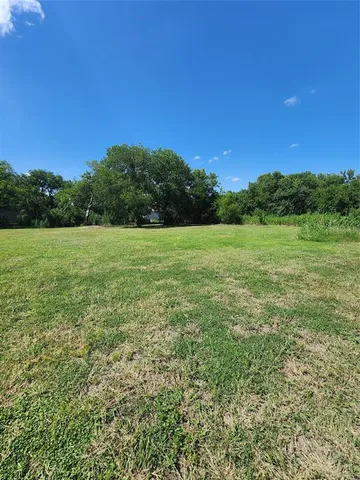a view of field with trees in the background