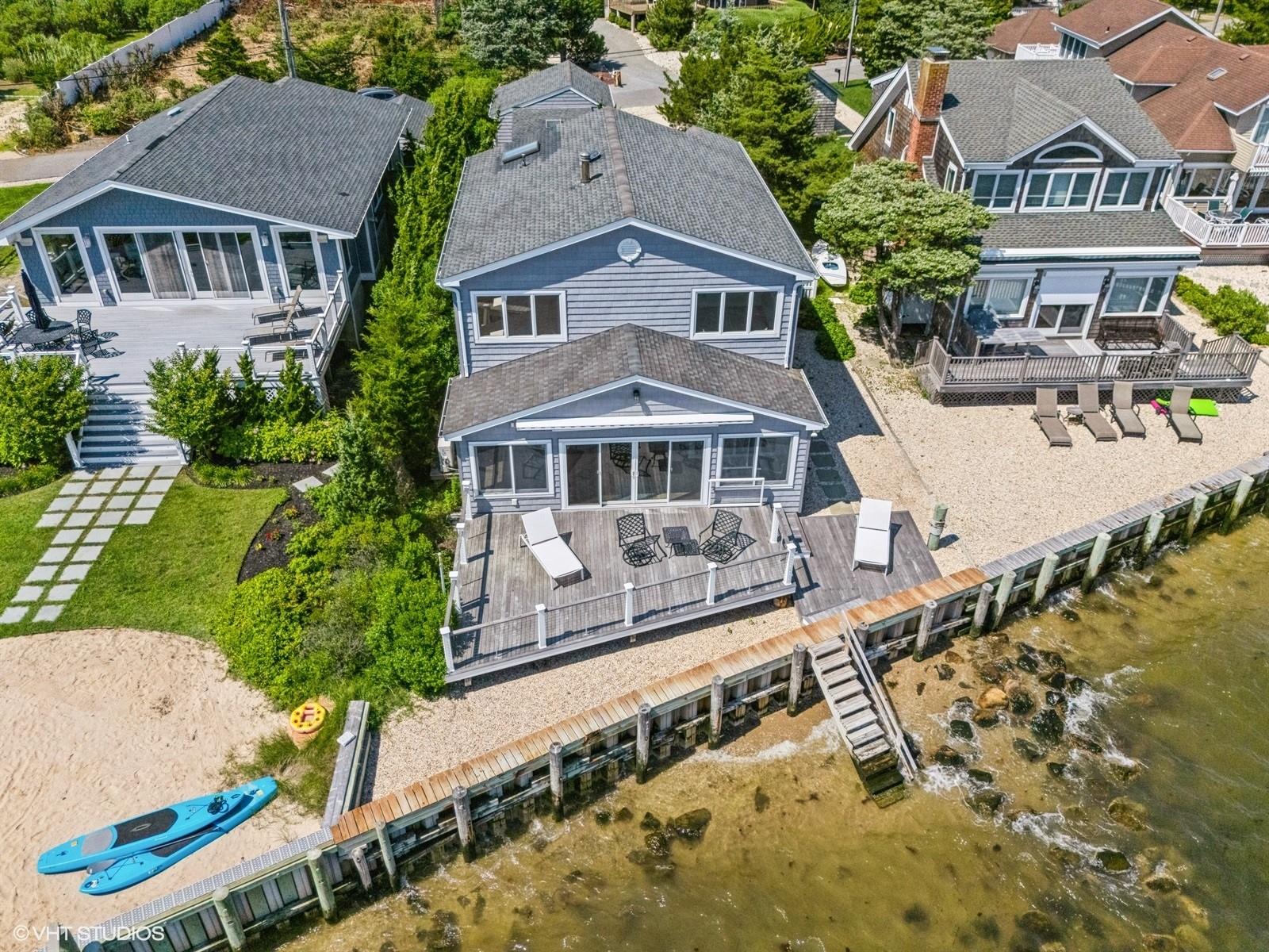 Aerial view of property and surrounding area featuring a large body of water