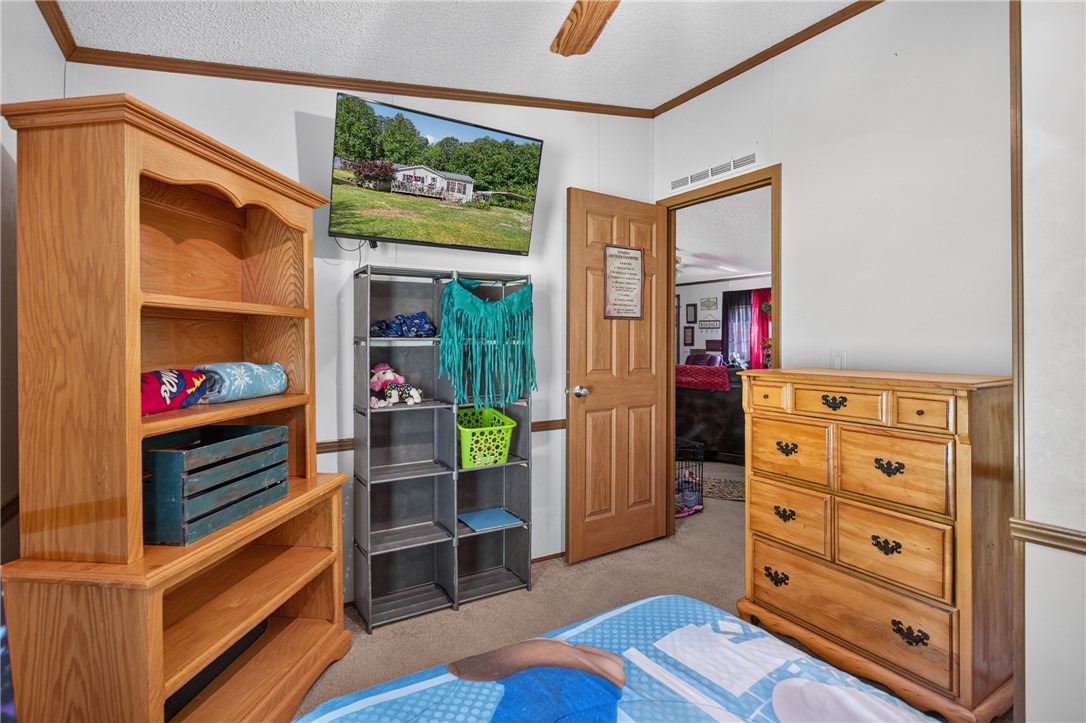418 Chauga Road Westminster, SC 29693 - Photo 18 of 38 Natural light illuminates the comfortable bedroom, offering a peaceful retreat within the home.