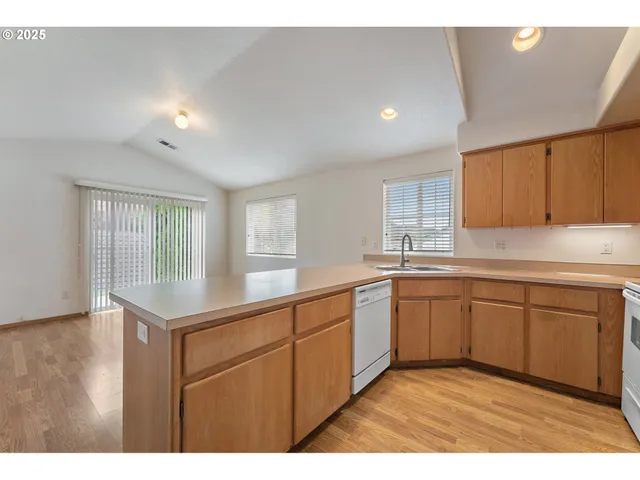 a kitchen with sink and cabinets