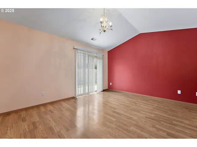a view of an empty room with a chandelier