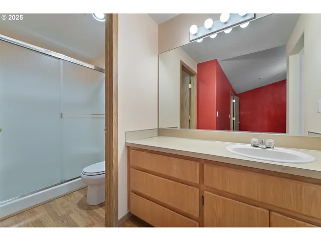 a bathroom with a sink a toilet and mirror