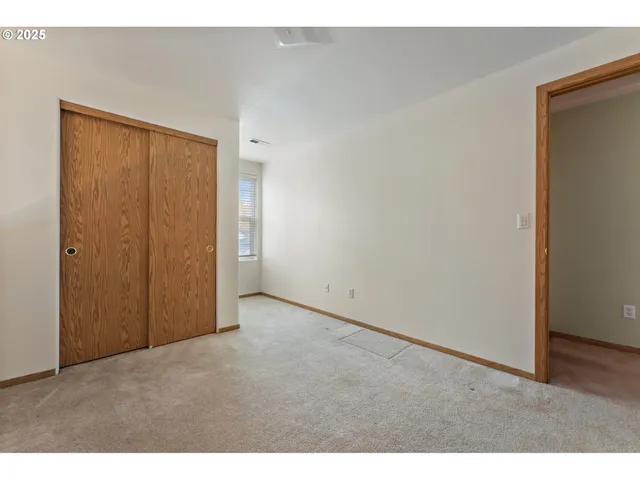 a view of an empty room and wooden floor