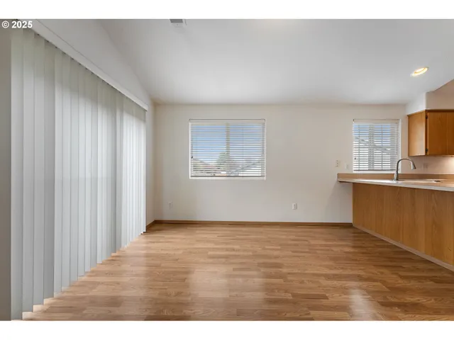 a view of a kitchen with wooden floor and a kitchen