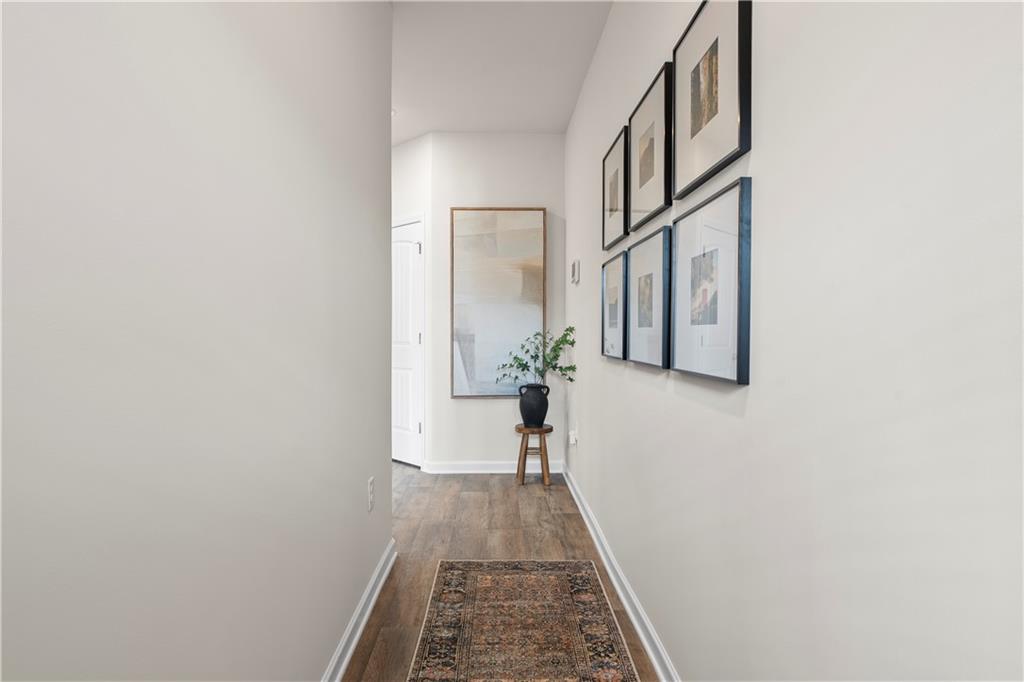 11531 Kimberly Court Hampton, GA 30228 - Photo 7 of 29 a view of a hallway with wooden floor and a bathroom