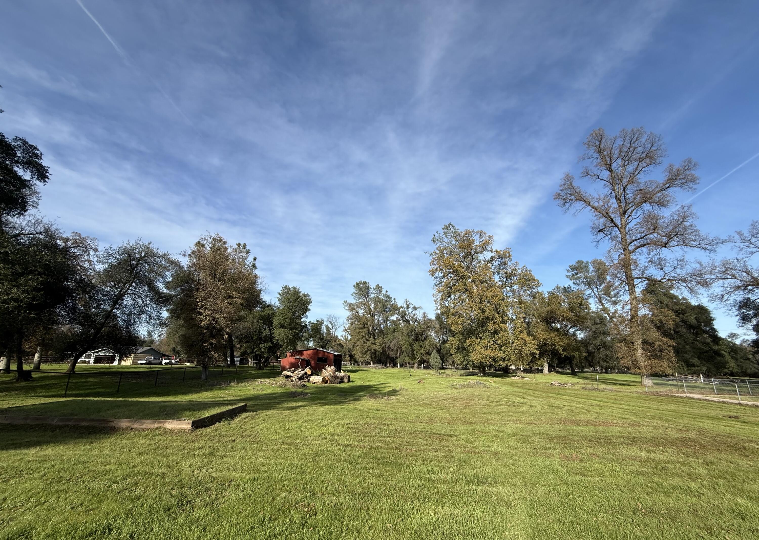 17140 Evergreen Road Cottonwood, CA 96022 - Photo 26 of 32 a view of a swimming pool and trees in the background