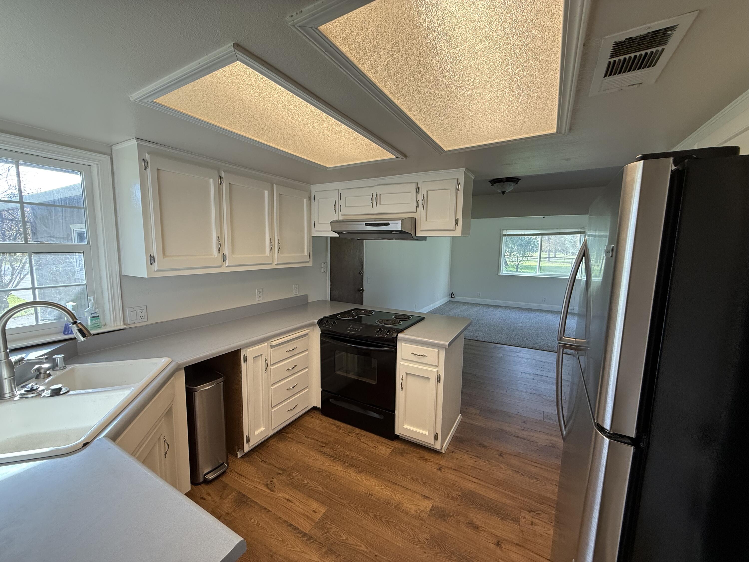 17140 Evergreen Road Cottonwood, CA 96022 - Photo 3 of 32 a kitchen with stainless steel appliances granite countertop a sink stove and refrigerator